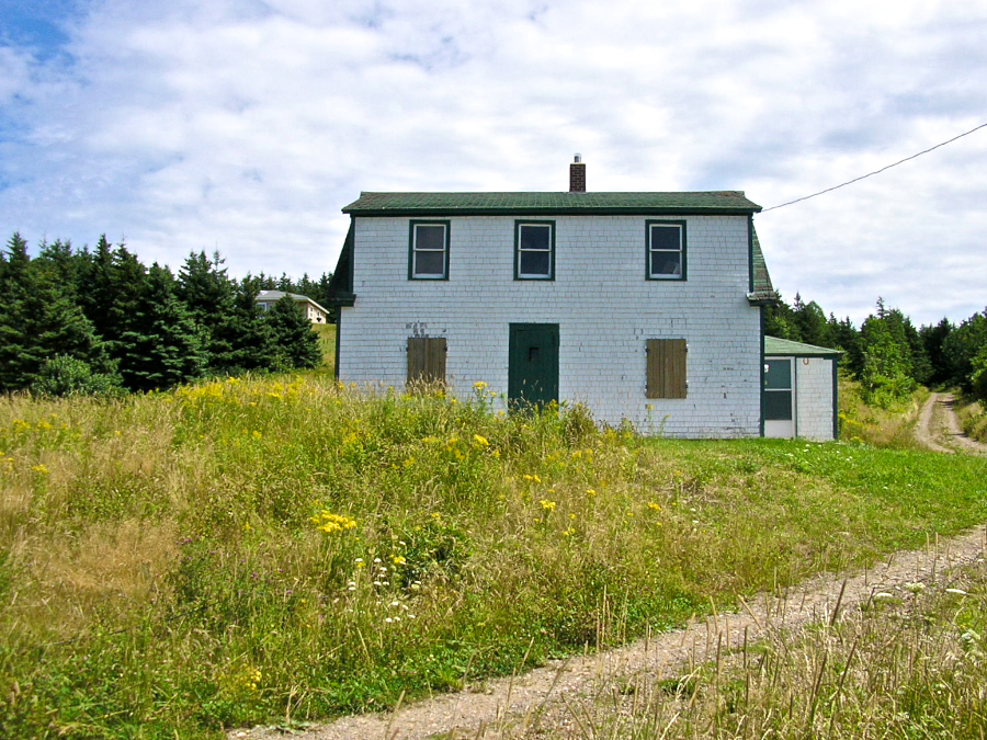 The two-storey white house with the dark green trim