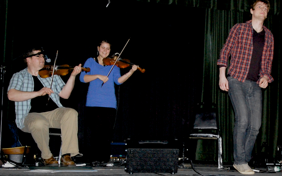 Photo of Koady Chaisson step-dancing to the music of J. J. Chaisson and Zoë Darrow